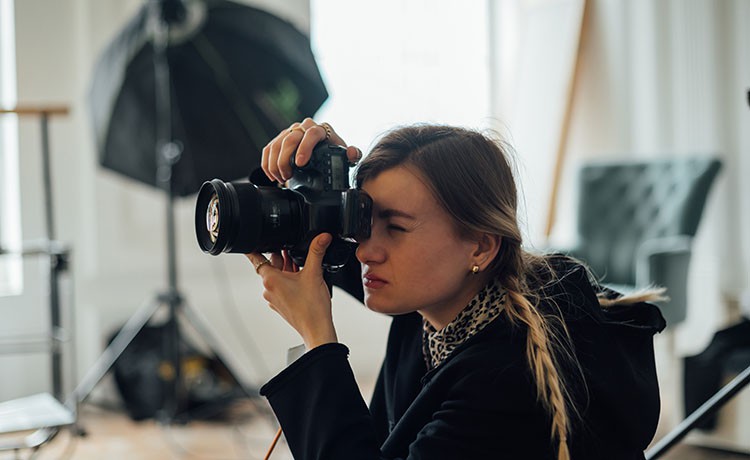 Fotodesignerin fotografiert Objekt.